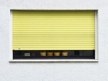 Close-up of closed shutter on window of store