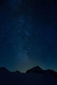 Scenic view of mountains against star field at night