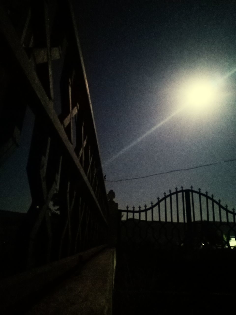 BRIDGE OVER RIVER IN CITY AGAINST SKY