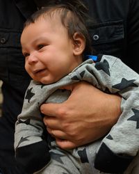 Close-up of person carrying cute baby 