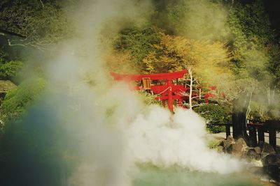 Smoke emitting from chimney on landscape