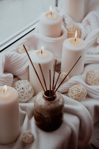 Close-up of illuminated candles on table