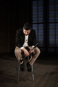 Young man sitting on floor