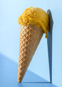 Close-up of ice cream against blue sky