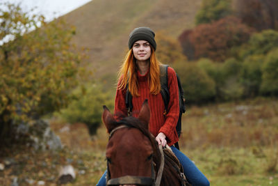 Beautiful young woman riding horse