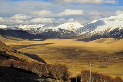 Scenic view of mountains against cloudy sky