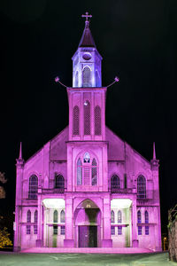 Illuminated building against sky at night