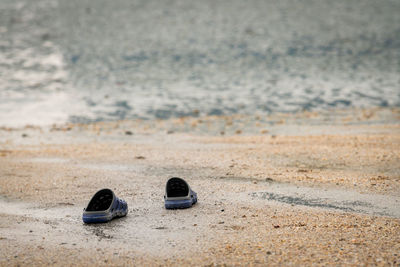 High angle view of shoes on beach