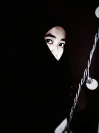 Portrait of man against black background