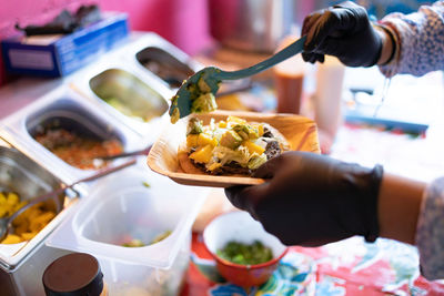 Cropped hand of person preparing food