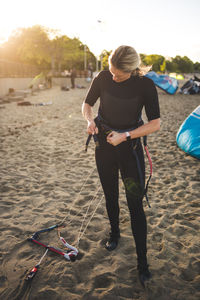 Rear view of woman standing on beach