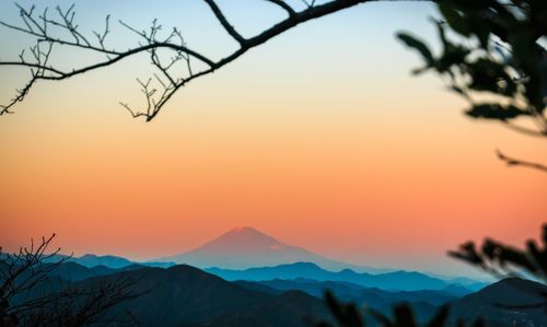 Distant view of mt fuji against sky during sunset