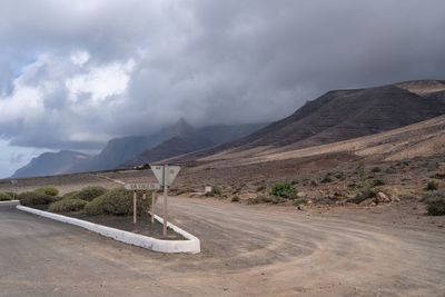 Road amidst mountains against sky