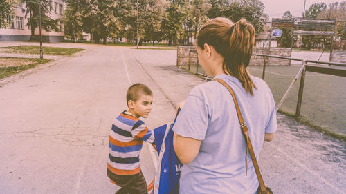 Rear view of boy walking outdoors