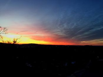 Silhouette of landscape against sky at sunset