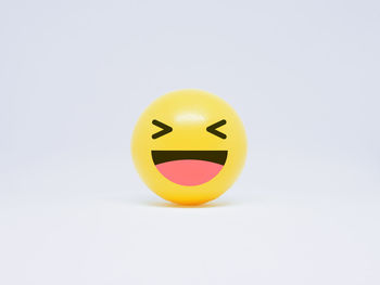 Close-up of smiley face against white background