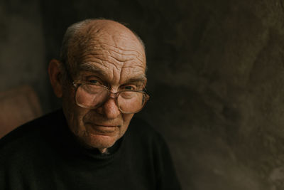 Close-up portrait of man against black background