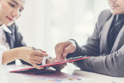 Business coworkers discussing over documents at office