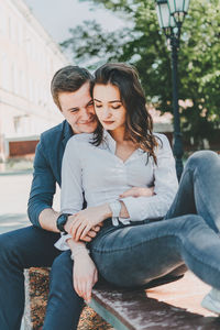 Young couple sitting outdoors