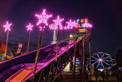 Illuminated ferris wheel at night