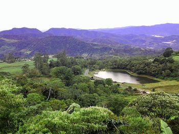 Scenic view of lake and mountains against sky