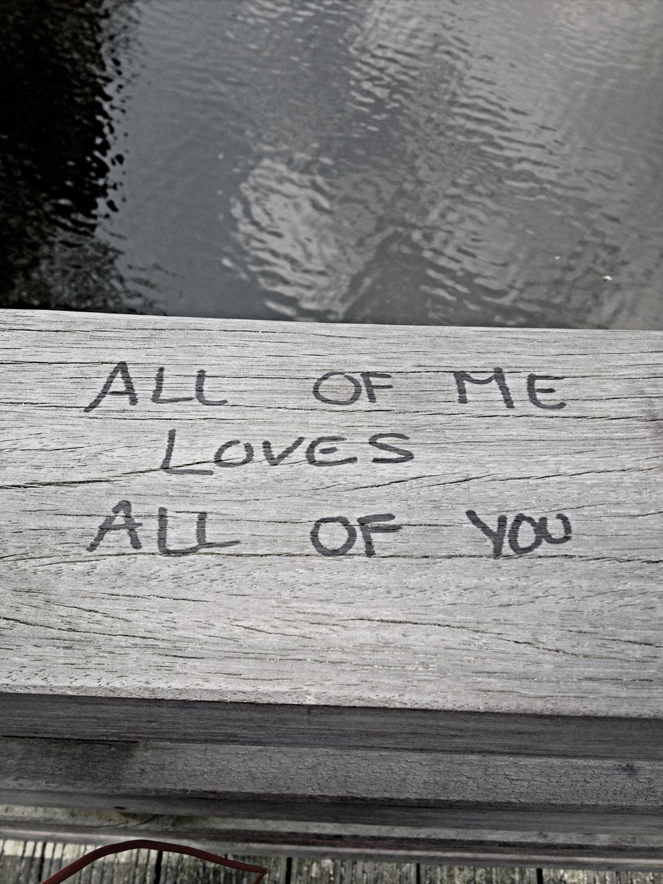 text, western script, water, wood - material, communication, wooden, high angle view, close-up, lake, plank, capital letter, day, outdoors, pier, no people, wood, rippled, textured, nature, love