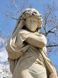 Low angle view of angel statue against sky