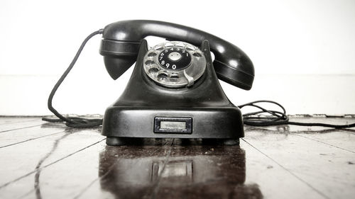 Close-up of telephone on table