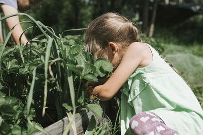 Rear view of girl with plants