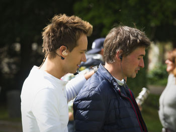 Side view portrait of two young men outdoors