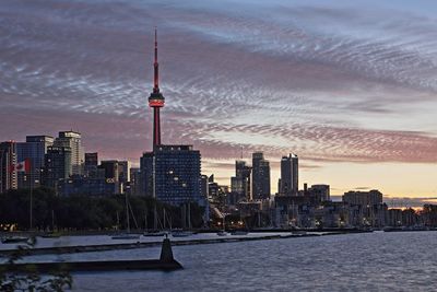 Modern buildings in city against cloudy sky