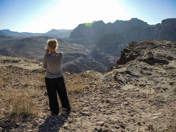 Woman standing on mountain road