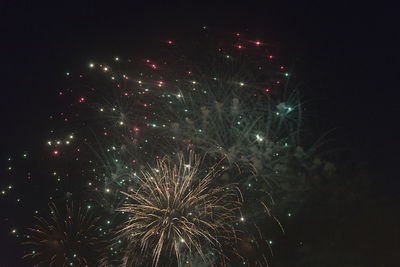 Low angle view of firework display at night