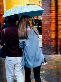 Rear view of woman standing in the dark