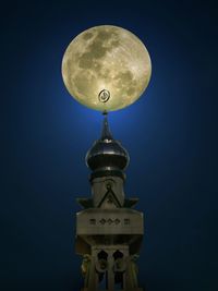 Low angle view of illuminated lamp against sky at night