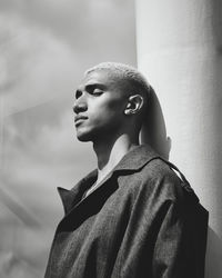 Close-up of man with closed eyes standing outdoors