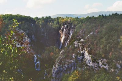Scenic view of waterfall against sky