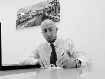 Portrait of young man sitting at table