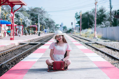 Portrait of woman on railroad station platform