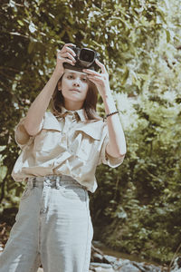 Series photo of young woman photographer with her camera shooting photo outdoor