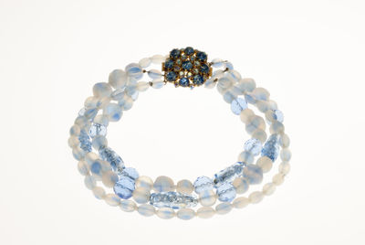 Close-up of necklace on white background