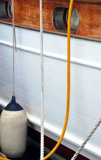 Close-up of rope hanging against wall at home