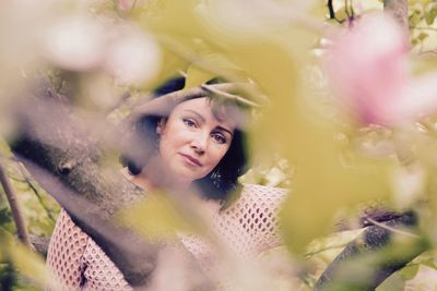 Portrait of smiling young woman with flowers