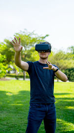 Man wearing virtual reality simulator in park