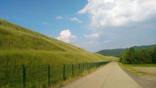 Country road passing through field