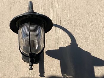 Close-up of electric lamp hanging on wall