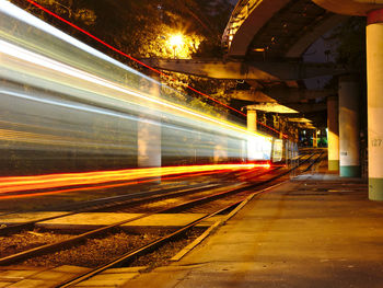 Blurred motion of train at railroad station during night