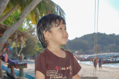 Cute boy looking away at beach
