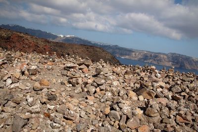 Rocks on volcano against sky