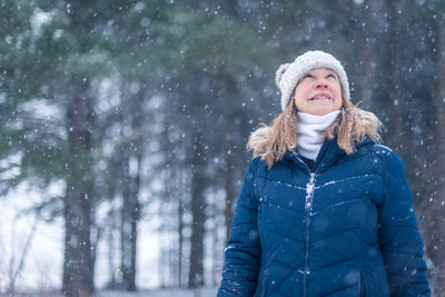 Woman in snow covered forest